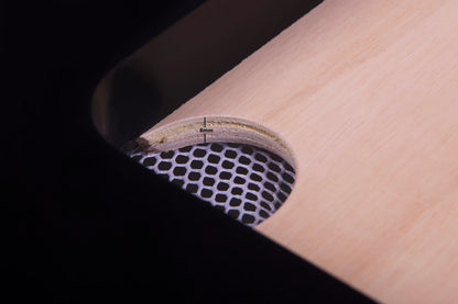 Close-up of a wooden paddle with a textured surface and visible brand name.